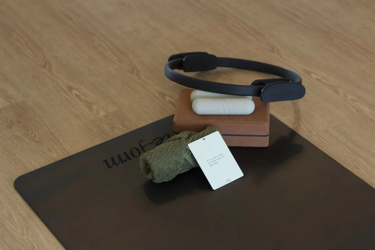 Pilates ring, block, towel and a Reform mat set up in the studio